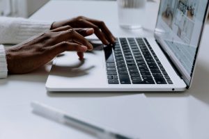 Black woman opening email on imac to get daily dose of wellness from the Real Life Wellness Membership